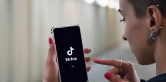 Person using TikTok app on smartphone.