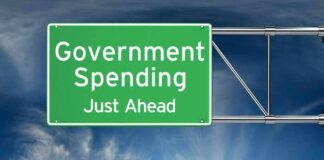 Green road sign: "Government Spending Just Ahead."