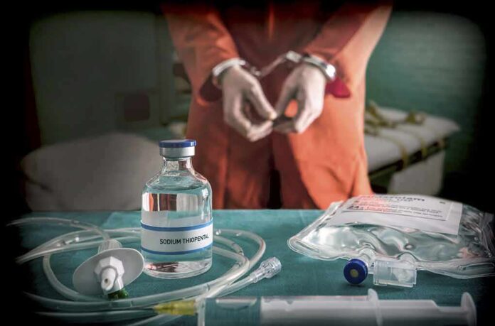 Handcuffed person in orange jumpsuit with medical supplies