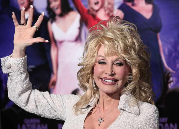 Woman smiling and waving on red carpet event