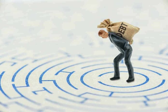 plastic man in a suit carrying a bag of money on his back over a flat map of a maze