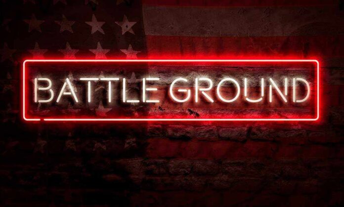 the word BATTLEGROUND in neon in front of an American flag.