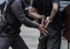 Police officer arresting a person with handcuffs
