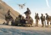Soldiers operating drone in desert environment during mission