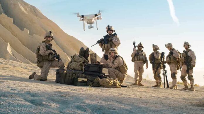 Soldiers operating drone in desert environment during mission
