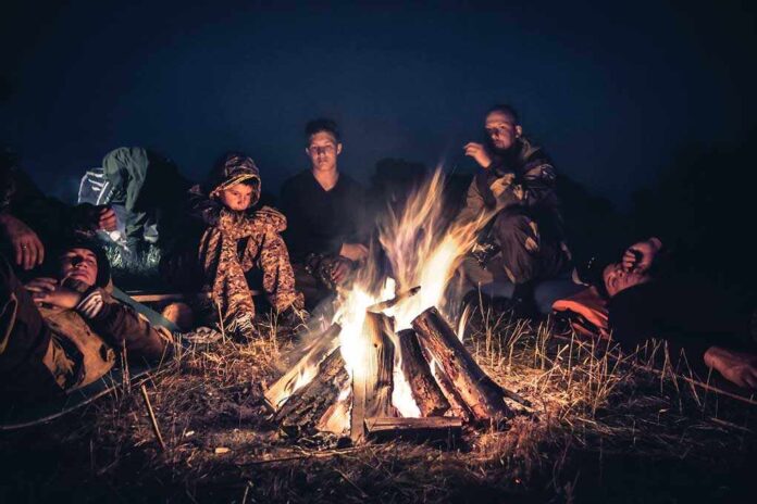 People sitting around a campfire at night