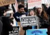 Group holding prolife and antiabortion signs at rally