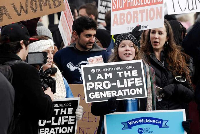 Group holding prolife and antiabortion signs at rally
