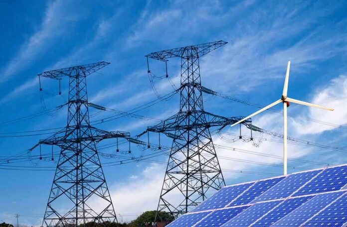 Power lines solar panels and wind turbine against sky