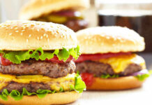 Cheeseburgers with lettuce tomato and sesame seed buns