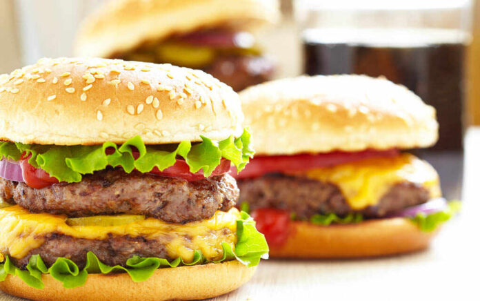 Cheeseburgers with lettuce tomato and sesame seed buns