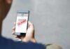 Person reading a scam message on a smartphone