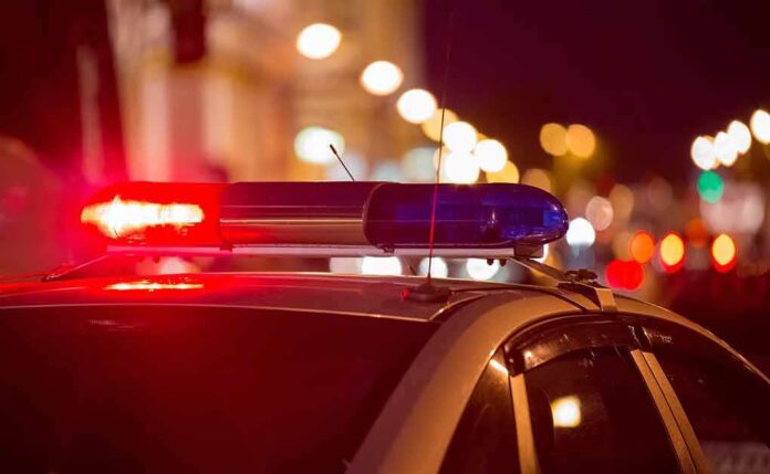 Police car with flashing lights at night.
