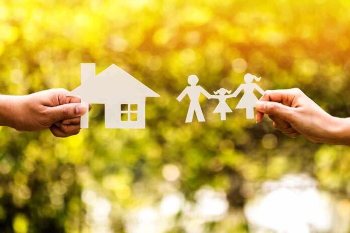Paper cutouts of a house and family outdoors
