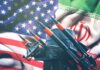Iran and USA flags with missile launcher