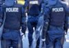 Police officers in riot gear with shields