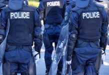 Police officers in riot gear with shields