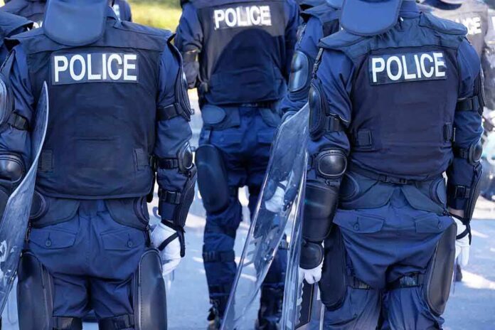 Police officers in riot gear with shields