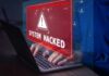 Warning sign System Hacked on laptop screen