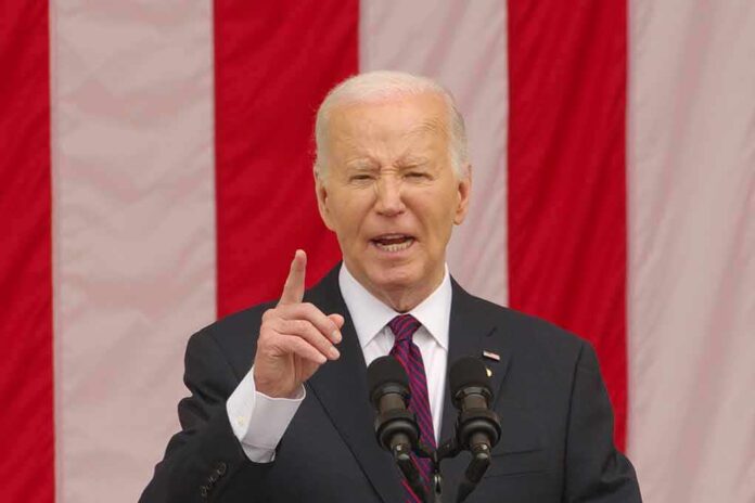 Man speaking in front of an American flag