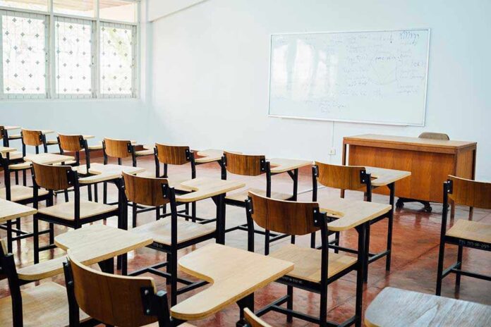 Empty classroom with desks chairs and whiteboard