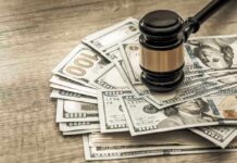 Gavel on a pile of hundred-dollar bills