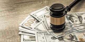Gavel on a pile of hundred-dollar bills