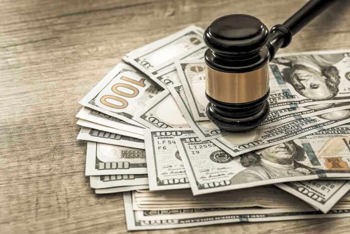 Gavel on a pile of hundred-dollar bills