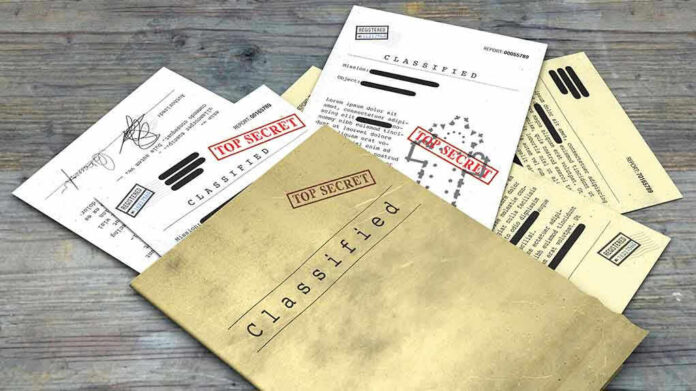 Classified documents with "Top Secret" stamps on wooden surface.