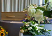 White roses in front of a casket