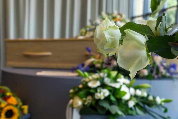 White roses in front of a casket
