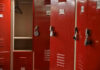 Red lockers with padlocks, one open with hanger