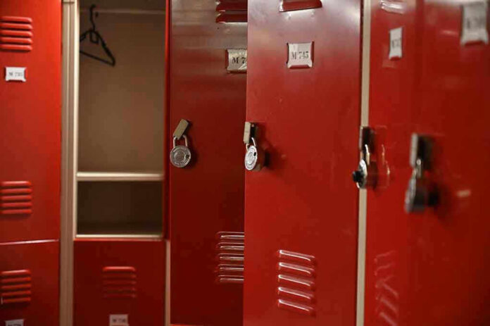 Red lockers with padlocks, one open with hanger
