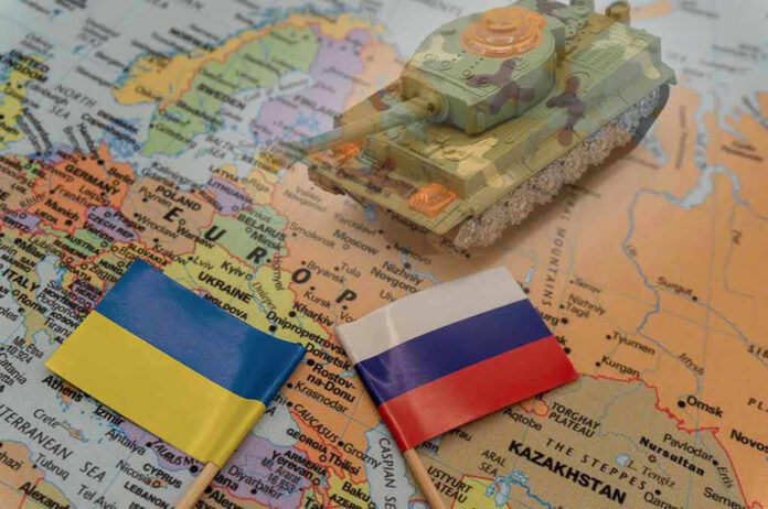 Toy tank on map with Ukraine and Russia flags