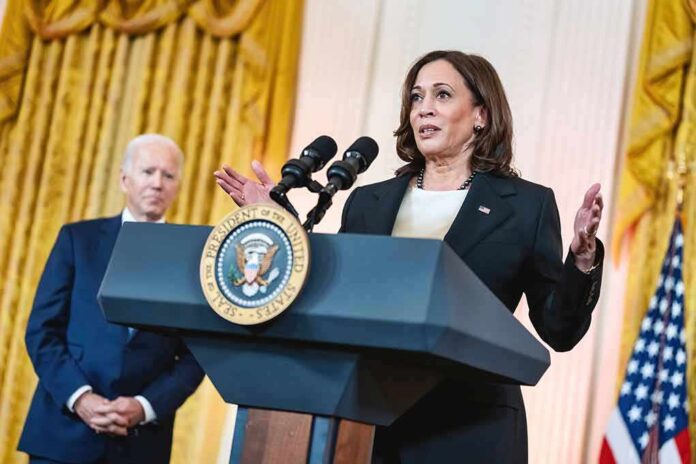 Two people speaking at a podium with microphones