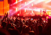 Crowd at concert with vibrant stage lights