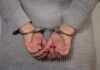 Person in handcuffs with gray sweater