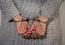 Person in handcuffs with gray sweater