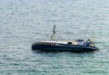An abandoned boat floating on the ocean surface