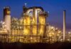 An industrial facility with illuminated structures at night