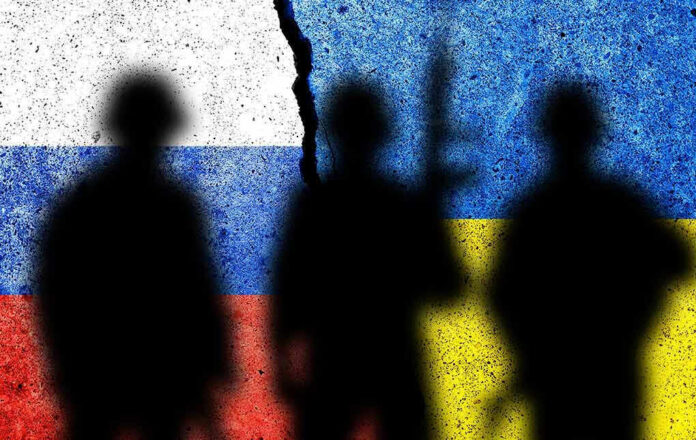 Silhouettes against split Russian and Ukrainian flags