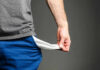 Person pulling out empty pocket from shorts