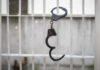 Handcuffs hanging on a barred window