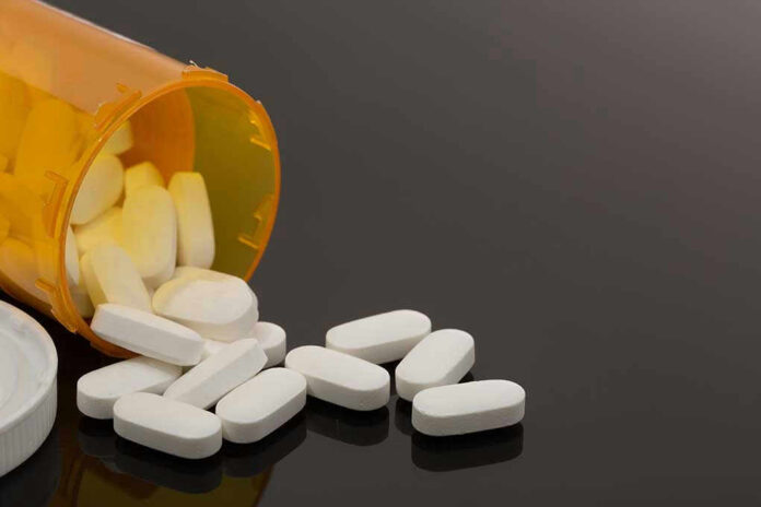 Spilled prescription bottle with white pills