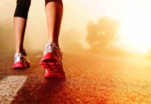Person jogging on a road during sunrise