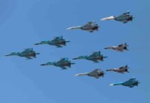 A formation of military jet fighters flying in a clear blue sky