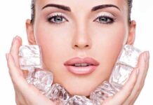 Close up of a woman holding ice cubes around her face