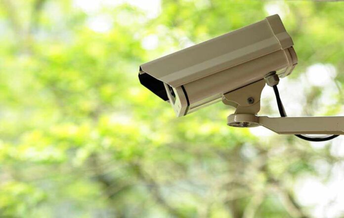 shutterstock_75189394.jpg A security camera mounted outdoors with a blurred green background