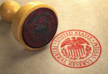 Federal Reserve stamp and wooden stamp on paper