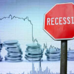 Recession sign, coin stacks, downward stock chart background.